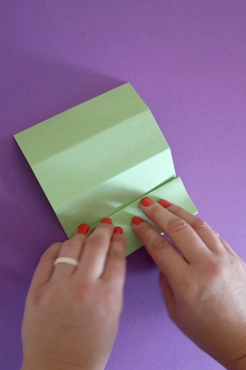 folding green paper back and forth